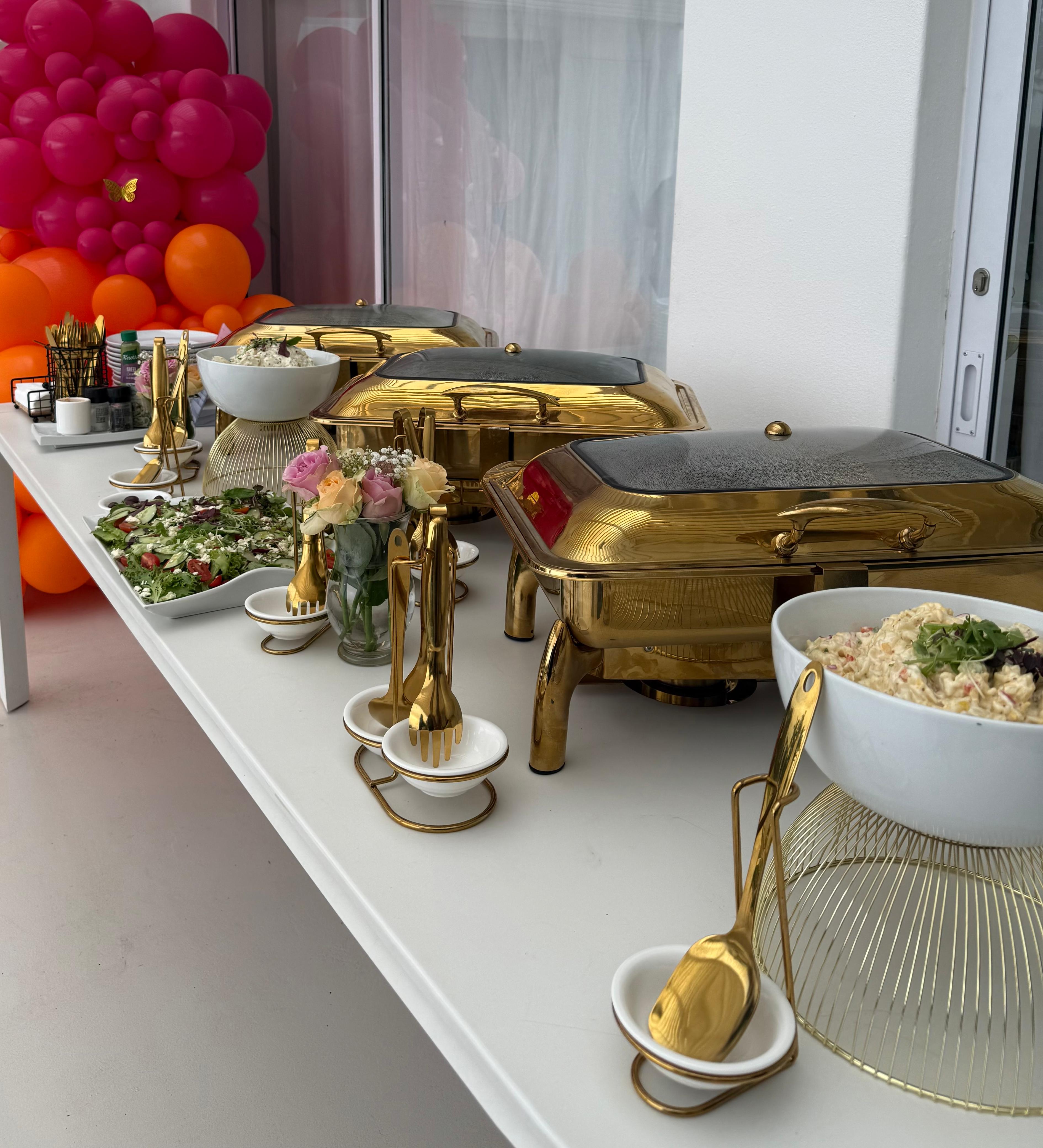 Beautiful three-tier wedding cake with premium catering display